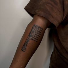 a man with a tattoo on his arm holding a fork and knife in one hand