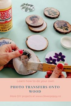 a woman is painting pictures on wood with paintbrushes and other crafting supplies