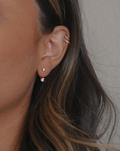 a close up of a person with ear piercings