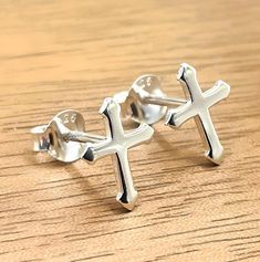 Discover the perfect blend of elegance and spirituality with our exquisite 925 Sterling Silver Cross Push-Back Stud Earrings! These beautiful earrings are meticulously crafted from high-quality 925 sterling silver, ensuring durability and shine that lasts. Measuring 5/16 inches in width and 13/32 inches in length, they strike the ideal balance between subtlety and statement, offering a timeless accessory that complements any outfit effortlessly. Each earring is stamped with "925" to guarantee it Spiritual Sterling Silver Earrings For Anniversary, White Gold Cross Earrings For Gift, Silver Spiritual Hallmarked Earrings, Cross Stud Earrings, Cross Earrings Studs, Cross Design, Everyday Accessories, Sterling Silver Cross, Timeless Accessories