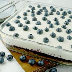 a cake with blueberries on top and white frosting