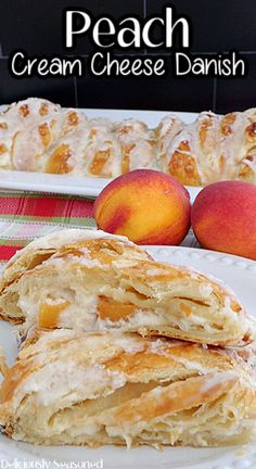 peach cream cheese danish on a white plate with two peaches in the back ground