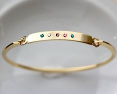 "Our Birthstone Bangle is the perfect gift for mothers, new moms, friends, or for you! TO ORDER 1) Select your quantity 2) Select your number of birthstones 3) Enter bracelet details in the personalization box DESCRIPTION * Bangle is gold plated over brass * Bangle measures 7.5\" in circumference - not adjustable * Handmade to order, please allow 3-5 days for us to make your item before shipping * Listing is for one bangle, others shown are sold separately We use the following birthstones: Janua Gold Bangle With Birthstone For Gift, Gold Bangle With Birthstone As Gift, Birthstone Bangle Bracelets For Gifts, Friendship Birthstone Bracelets For Mother's Day, Adjustable Birthstone Bracelets As Gift For Mom, Mother's Day Friendship Bracelet With Birthstone, Gold Birthstone Bracelet As Gift For Mom, Gold Birthstone Bracelet For Mom, Gold Friendship Bracelets With Birthstone