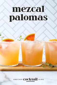 three glasses filled with orange margaritas on top of a cutting board