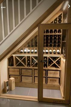 an open wine cabinet under the stairs