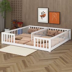 a living room with wood flooring and white furniture on top of wooden parquet floors