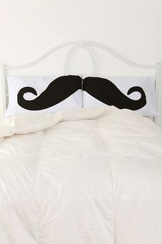 a white bed with a black mustache on it