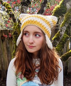 a girl with red hair wearing a knitted hat