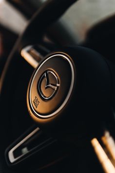 the interior of a car with steering wheel controls and dashboard knobs, including an automatic button