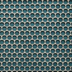 a close up view of a metal grate with circles on it