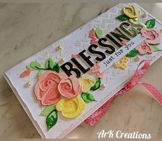 a close up of a card on a table with flowers and words that say blessing