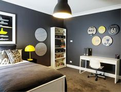 a bedroom with black walls and white furniture