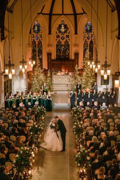 a bride and groom kissing in front of an audience