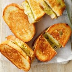 grilled cheese sandwiches cut in half on top of a piece of paper