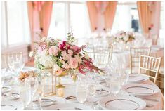 the table is set with white and pink flowers