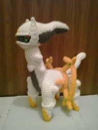 two knitted animals standing next to each other