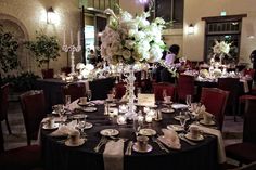 a table set with plates and silverware for an elegant wedding reception at the four seasons hotel