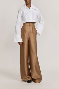 Elegant speckled beige pants with a subtle textured finish Wide-leg design for a relaxed and flowing silhouette High-waisted fit for a flattering and elongating effect Ideal for pairing with blouses or tailored tops for a sophisticated look Perfect for both casual and formal occasions Made from crepe Made in Portugal Tailored Tops, Brand Manifesto, Structured Design, Oversized Collar, Beige Pants, Cropped Shirt, New Arrival Dress, Crop Shirt, Formal Occasion