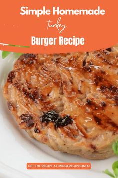 a hamburger on a white plate with lettuce and tomato garnishes