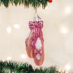 a pink ornament hanging from a christmas tree