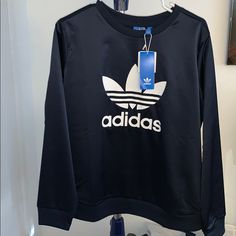 Nwt Adidas Navy Blue Silky Pullover Sweatshirt Limited Edition Size L New With Tags Never Worn 93% Polyester 7% Spandex Has A Small Hole On The Neck Where The Sensor Was..Took This On A Trip And They Unfortunately Left It On We Couldn’t Get It Off So The Flight Had To Cut It Or Else We Would’ve Had To Throw It Away :/ (Seen In 4th Pic Of The Back Of The Sweater Zoom In On The Neck Band Very Small And Hardly Noticeable) -Price Reflects Because Of This Blue Adidas Long Sleeve Tops, Adidas Blue Long Sleeve Tops, Adidas Navy Sporty Tops, Navy Adidas Sporty Top, Navy Sporty Adidas Tops, Sporty Navy Adidas Tops, Blue Stretch Sportswear Sweatshirt, Blue Stretch Sweatshirt In Sportswear Style, Casual Navy Adidas Top