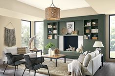 a living room filled with furniture and a fire place in the middle of a room