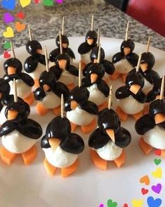 there are many penguin shaped treats on the plate