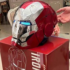 the iron man helmet is sitting on top of a box