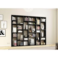 a book shelf filled with lots of books on top of a hard wood floor next to a white wall