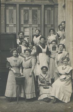 an old black and white photo of women in dresses