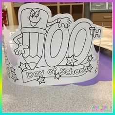 a paper crown with the words 100th day of school written in black and white