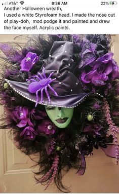 a purple and black witch's hat on top of a door