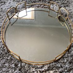 a round mirror sitting on top of a rug