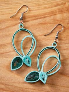 the earrings are made out of wire and have blue leaves on them, as if they were