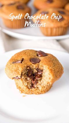 a chocolate chip muffin on a white plate with the words, speltt chocolate chip muffins