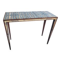 a wooden table with blue and white designs on the top, against a white background