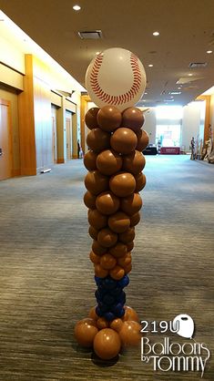 an inflatable baseball is on top of a ball at the end of a column