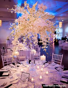 an elegant centerpiece with white flowers and candles