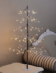 a small christmas tree with lights on it