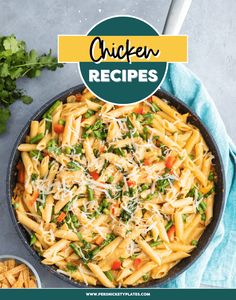 a skillet filled with pasta and vegetables on top of a blue towel next to some parmesan cheese