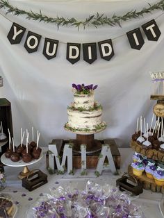 a table topped with lots of cakes and desserts