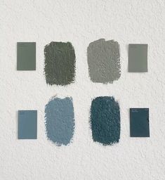 several shades of blue and green paint on a white wall with the same color swatches