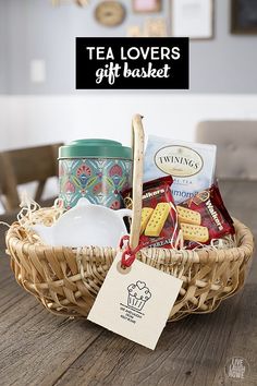 a wicker basket filled with tea, cookies and crackers on top of a wooden table