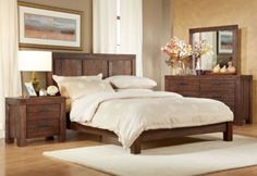 a bedroom scene with focus on the bed and dresser