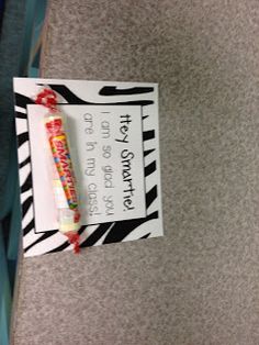 a candy bar wrapped in zebra print paper and tied to a sign on the floor