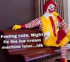 a clown sitting on top of a wooden bench next to a sign that says, feeling cute might fix the ice cream machine later