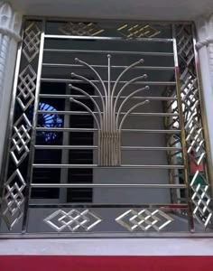 an iron gate with geometric designs on the front and sides, is seen in this image