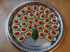 cucumbers arranged in the shape of a tree on a metal tray