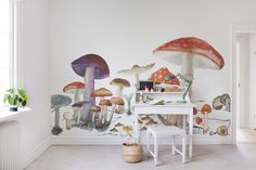 a white desk with mushrooms painted on the wall