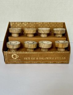 a set of eight wooden bowls in a cardboard box